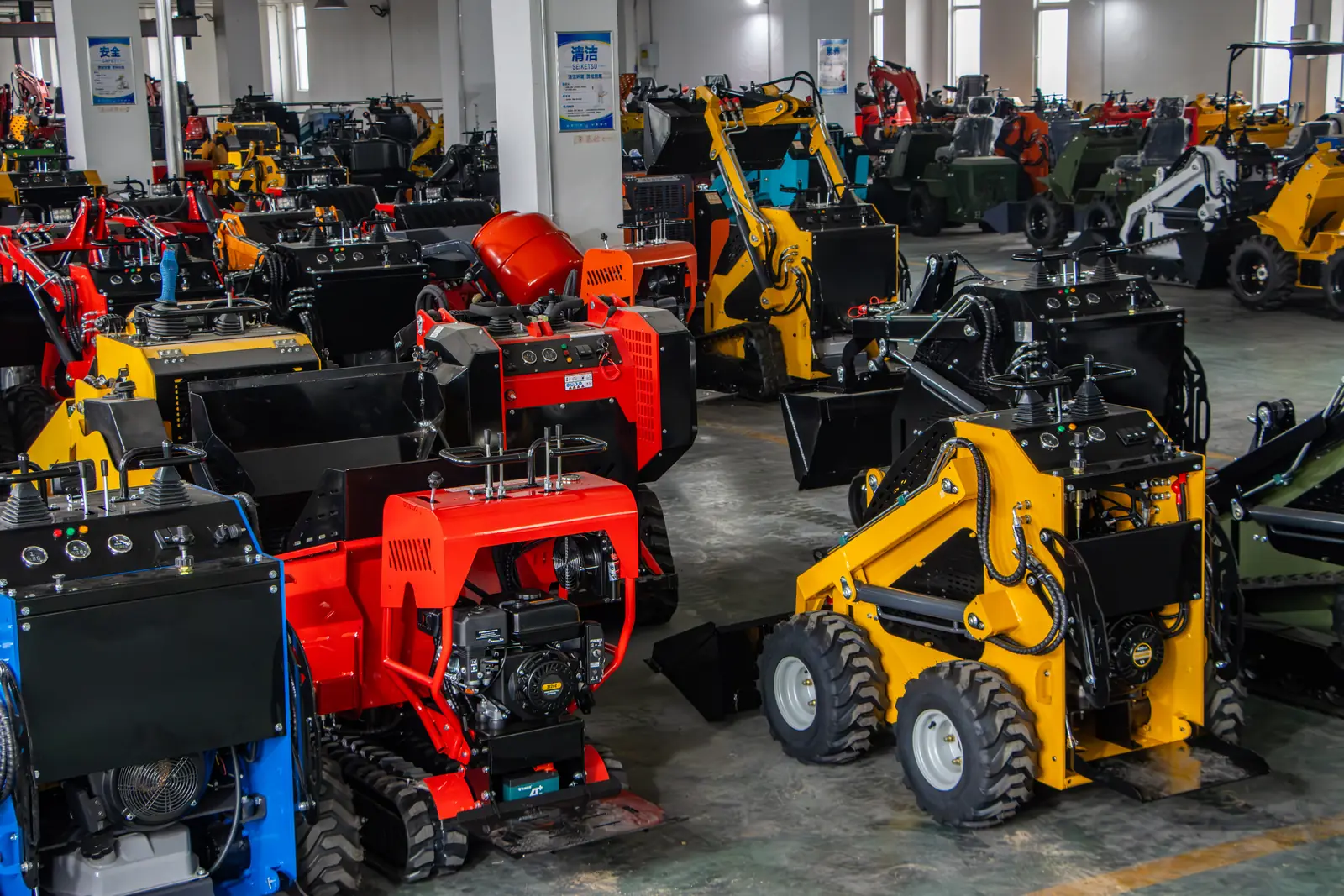Finished mini skid steer loaders in customer-ordered red, yellow and blue at the BOB-LIFT factory in Xuzhou