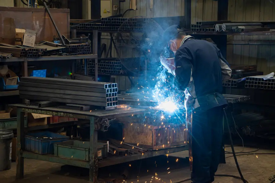 Welder at work on a loader frame at the BOB-LIFT factory in Xuzhou