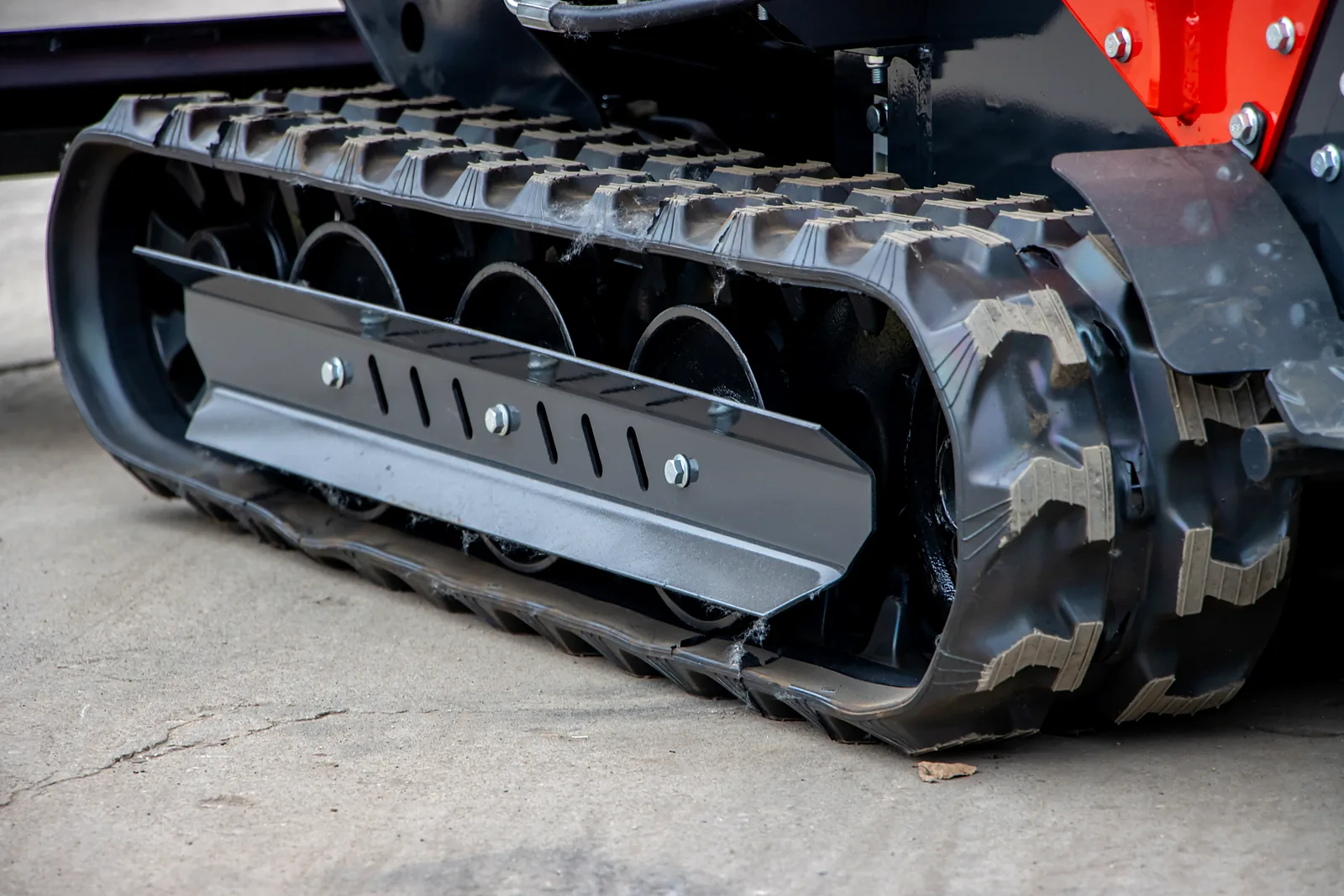 Close-up of the BL-T500-HD rubber track, showing the tread blocks, the road wheels behind the black side plate and the track frame